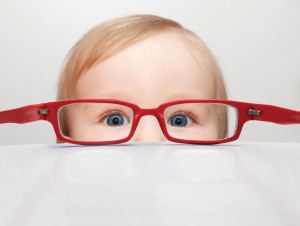 Toddler looking through glasses - treatment options for children